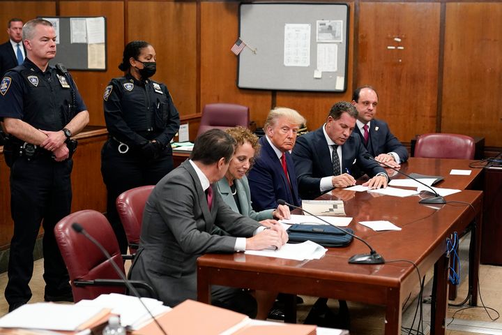 Former President Donald Trump, center, appears in court for his arraignment, on April 4, 2023, in New York.