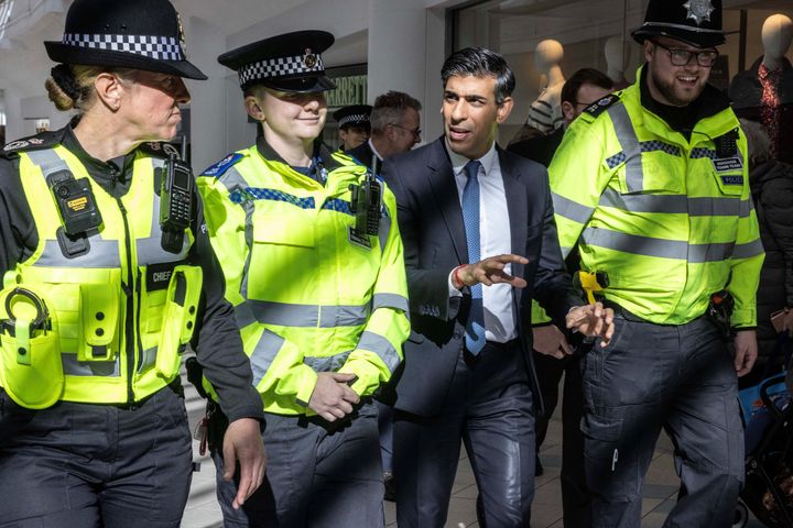 Rishi Sunak speaks with police officers at the Swan Walk shopping centre during a visit in Horsham, West Sussex.