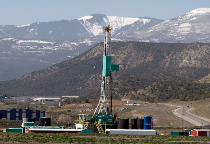 A natural gas well pad sits in front of the Roan Plateau near the mountain community of Rifle, Colorado.