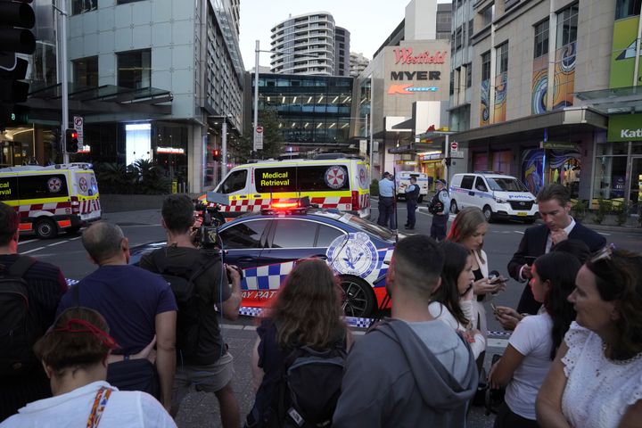 A crowd gathers outside Westfield Shopping Centre in Sydney, Saturday, April 13, 2024. Media reports say multiple people have been stabbed and that the police shot a person at the Sydney shopping center. (AP Photo/Rick Rycroft)