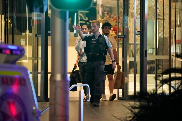People are led out of Westfield Shopping Centre, where multiple people were stabbed in Sydney, Saturday, April 13, 2024. Six people and a suspect were killed in a Sydney shopping center stabbing attack on Saturday that left multiple people, including a small child, injured, police said. (AP Photo/Rick Rycroft)