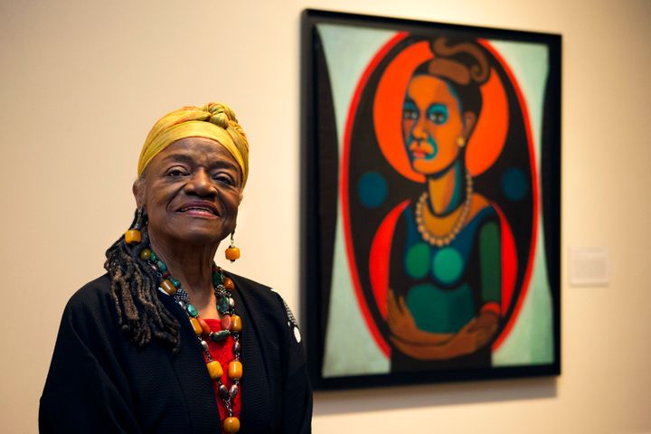 FILE - Artist Faith Ringgold poses for a portrait in front of a painted self-portrait during a press preview of her exhibition, "American People, Black Light: Faith Ringgold's Paintings of the 1960s" at the National Museum of Women in the Arts in Washington, June 19, 2013. (AP Photo/Jacquelyn Martin, File)