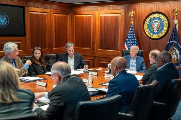In this image provided by the White House, President Joe Biden, along with members of his national security team, receive an update on an ongoing airborne attack on Israel from Iran, as they meet in the Situation Room of the White House in Washington, Saturday, April 13, 2024. From left to right, facing Biden are, Central Intelligence Agency Director William Burns; Avril Haines, Director of National Intelligence; Secretary of State Antony Blinken and National Security Advisor Jake Sullivan. Some papers on the desk have been blurred by the source for national security reasons. (Adam Schultz/The White House via AP)