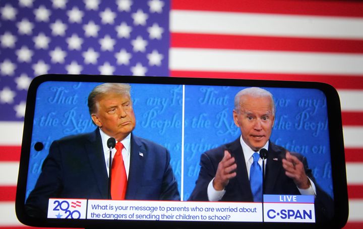 A voters watches Donald Trump and Joe Biden's final presidential debate of 2020 on a smart phone. Biden has yet to commit to a 2024 event with presumptive Republican nominee Trump.