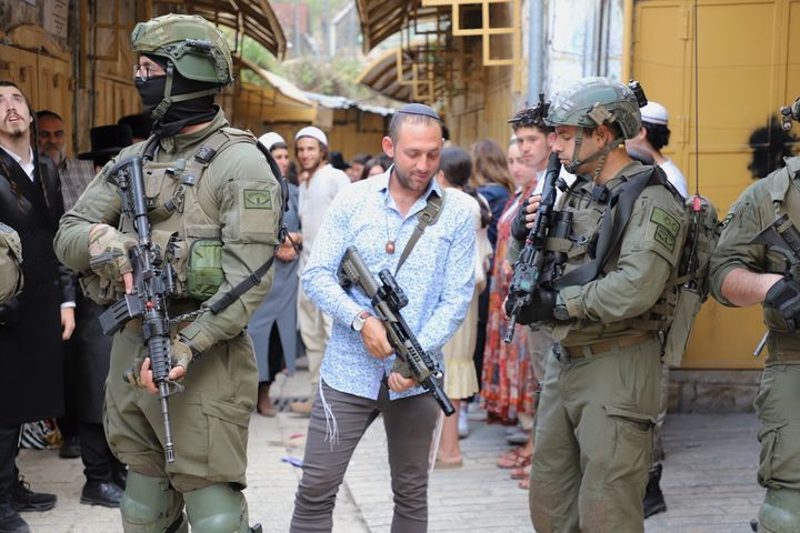 Jewish settlers enter with Israeli Security Forces during a raid in Hebron, West Bank on April 13, 2024.