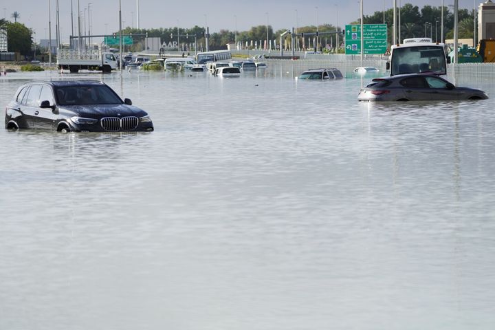 Vehicles sit abandoned in floodwater covering a major road in Dubai, United Arab Emirates, on April 17, 2024.