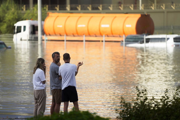 People look out at floodwater covering a major road in Dubai, United Arab Emirates, on April 17, 2024.