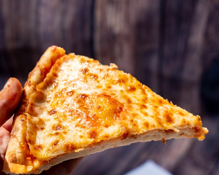 Spicy Pizza ready to eat on wooden background stock photo at June 08, 2021 England