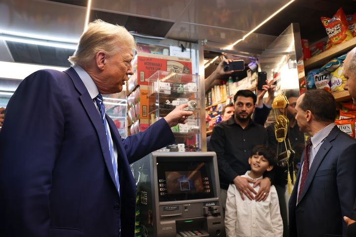 Former President Donald Trump talks with bodega owner Maad Ahmed, center, during a visit to his store, on April 16, 2024, in New York.