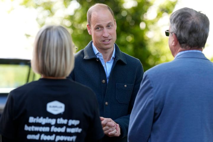 Prince William is greeted as he arrives for a visit to Surplus to Supper on Thursday in Surrey, England.