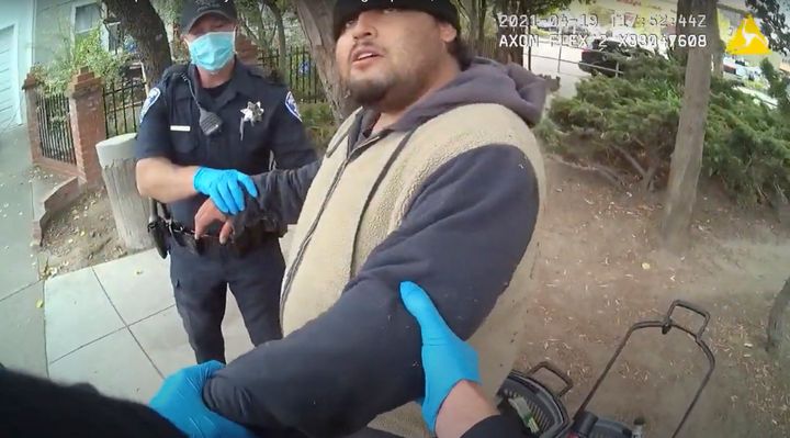 In this image from a body camera, Alameda Police Department officers attempt to take 26-year-old Mario Gonzalez into custody on April 19, 2021. The video later shows officers pinning Gonzalez to the ground face-down.