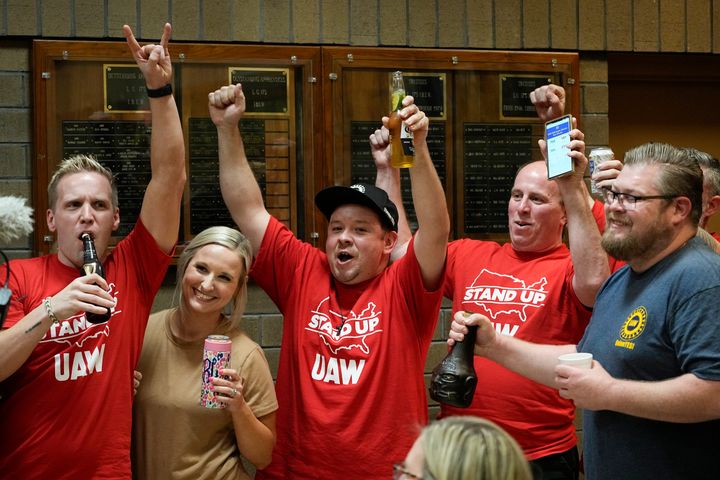 Volkswagen automobile plant employees celebrate as they watch the results of a UAW union vote, late Friday, April 19, 2024, in Chattanooga, Tenn. (AP Photo/George Walker IV)