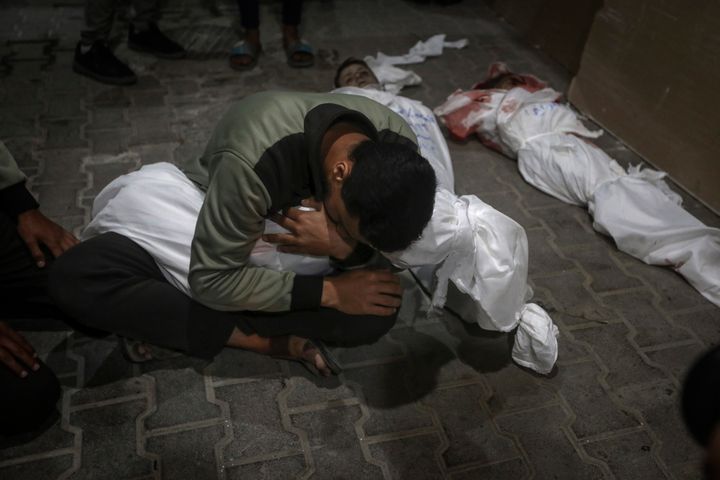 A Palestinian child mourns his relative killed in the Israeli bombardment of the Gaza Strip, at the morgue of the Kuwaiti Hospital in Rafah refugee camp, southern Gaza Strip, early Saturday, April 20, 2024. (AP Photo/Ismael Abu Dayyah)