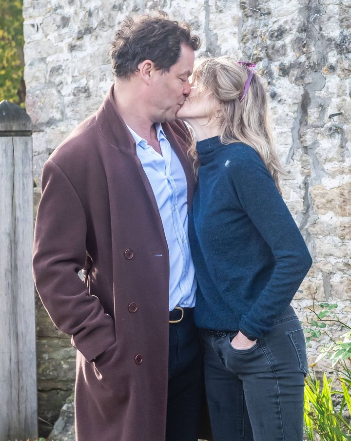 Dominic West and wife Catherine FitzGerald kiss outside their home after presenting photographers with a note addressing the state of their marriage