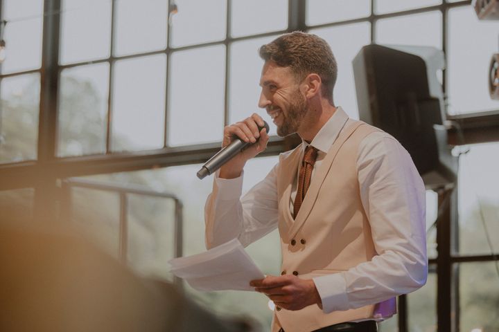 Man making a speech at a wedding.