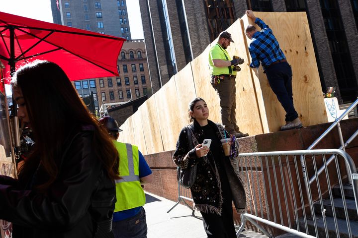 Workers erected a wooden wall at Gould Plaza outside of the New York University Stern School of Business after an encampment set up by students was cleared out on Monday night.