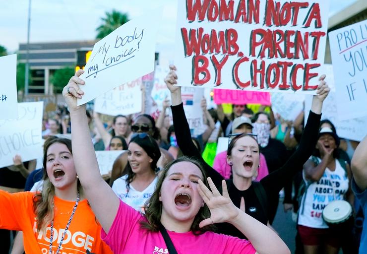 Protesters march around the Arizona Capitol in Phoenix after the U.S. Supreme Court decision to overturn Roe v. Wade on June 24, 2022. The court will hear oral arguments Wednesday on emergency care in states with abortion bans. 