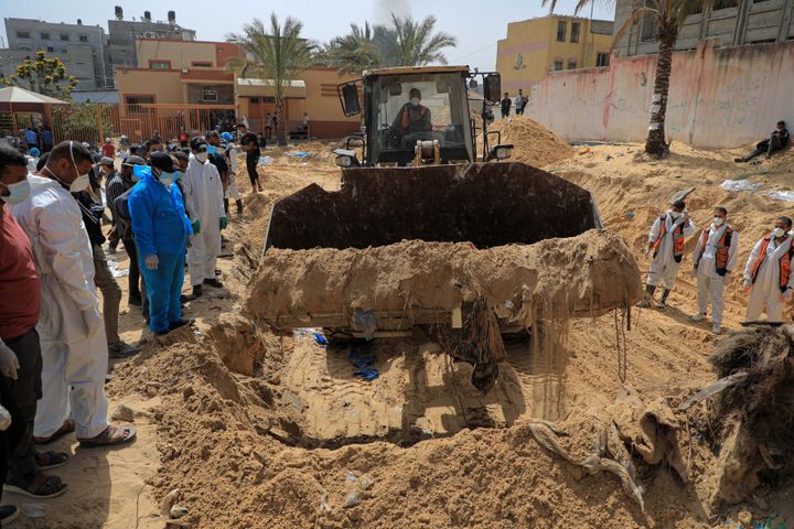 Workers uncover bodies found in a mass grave at Nasser Hospital in the southern Gaza Strip city of Khan Younis, on Tuesday.