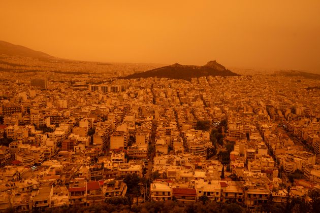 This photograph taken on April 23, 2024, in Athens shows a view of the city of Athens shrouded in haze, as southerly winds carried waves of dust to the city
