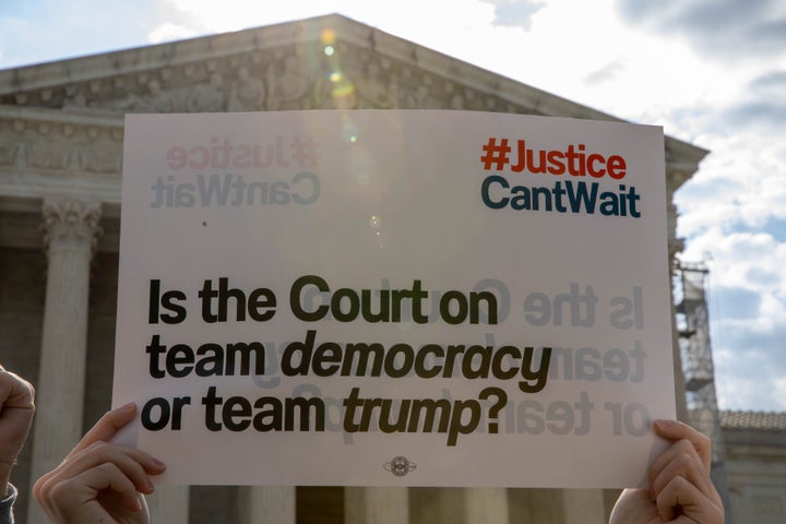 Protesters gathered outside the Supreme Court as it heard arguments Thursday on former President Donald Trump's claim of "absolute immunity" from criminal prosecution.