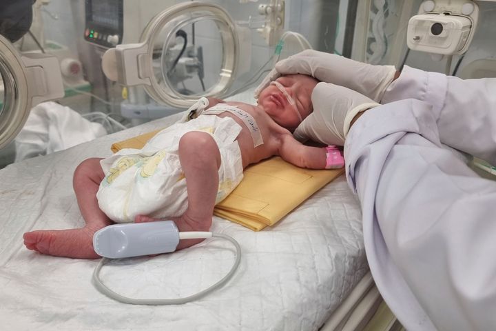 Palestinian baby girl, Sabreen Jouda, who was delivered prematurely after her mother was killed in an Israeli strike along with her husband and daughter, lies in an incubator in Gaza on April 21. The premature infant later died.