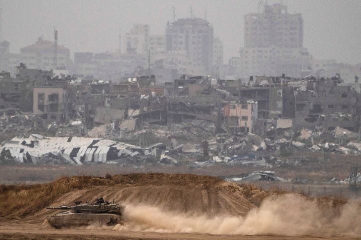 Israeli soldiers move on the top of a tank near the Israeli-Gaza border, as seen from southern Israel, Thursday, April 25, 2024. (AP Photo/Leo Correa)