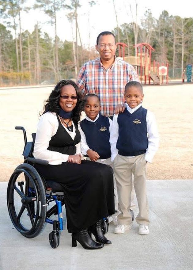 The author, husband Tharrow, and their two sons are shown at the children's school during a K-8 disability workshop in 2014.