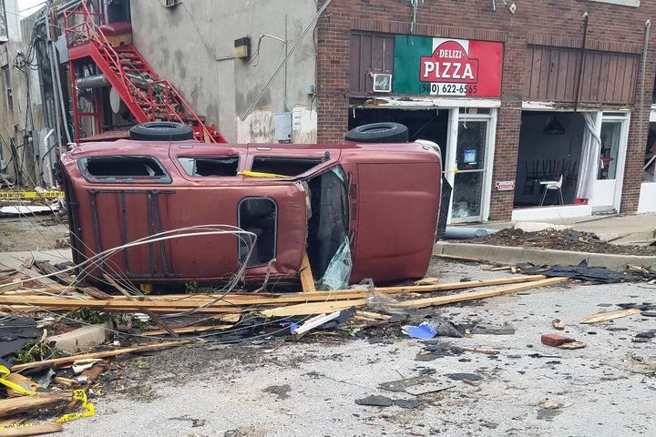 A car lies knocked over on its side after a tornado tore through Sulphur, Okla., on April 28, 2024. 