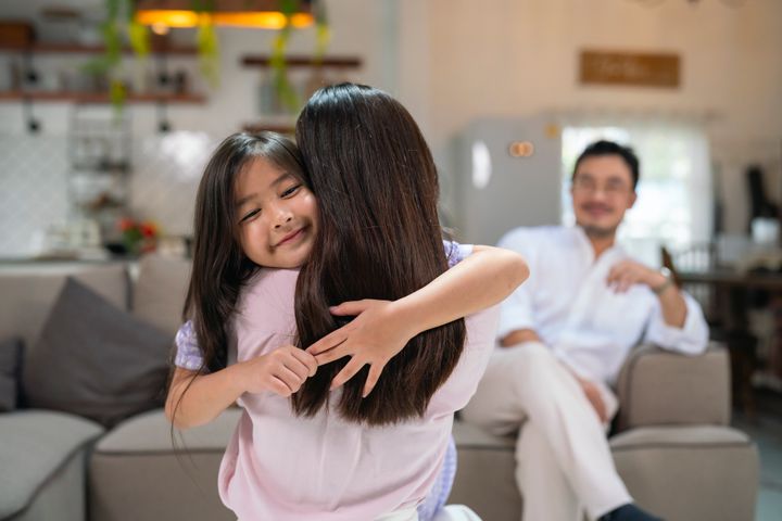 Little girl embracing her mother