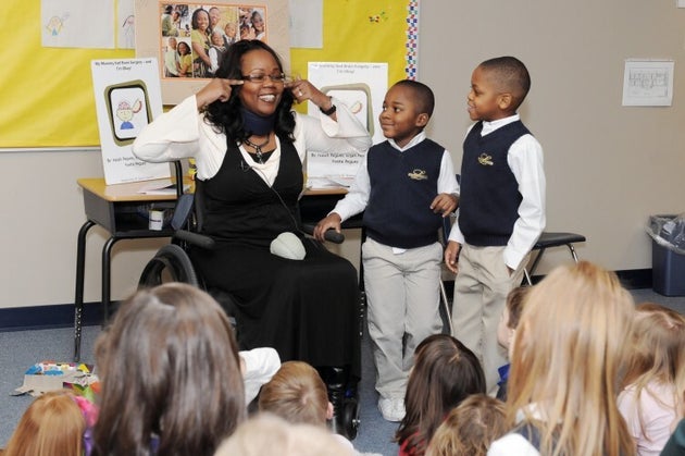 The author and her sons speak to the boys' classmates about her brain injury in 2014.