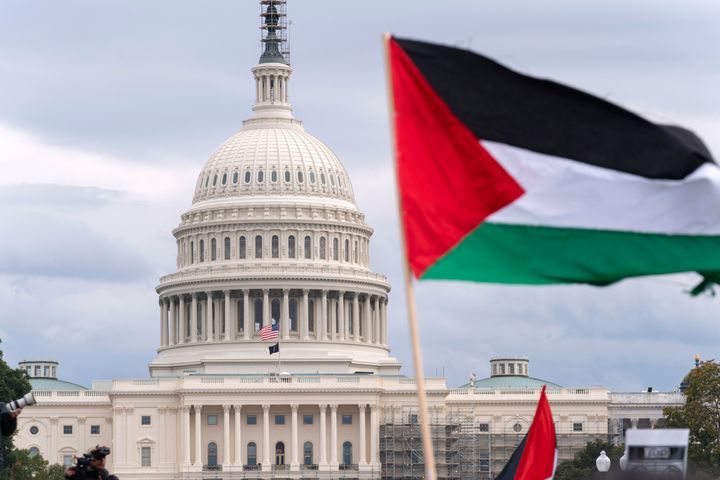 A Palestinian flag flies near the U.S. Capitol as people rally at the National Mall in a pro-Palestinian demonstration on Oct. 20. On Monday, Hawaii's legislature passed a resolution calling for a cease-fire in Gaza.