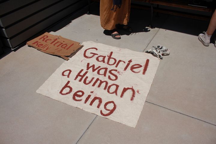 A sign referring to Gabriel Cuen-Buitimea, a Mexican man found dead on George Alan Kelly's ranch, sits outside the Santa Cruz County Courthouse Monday.