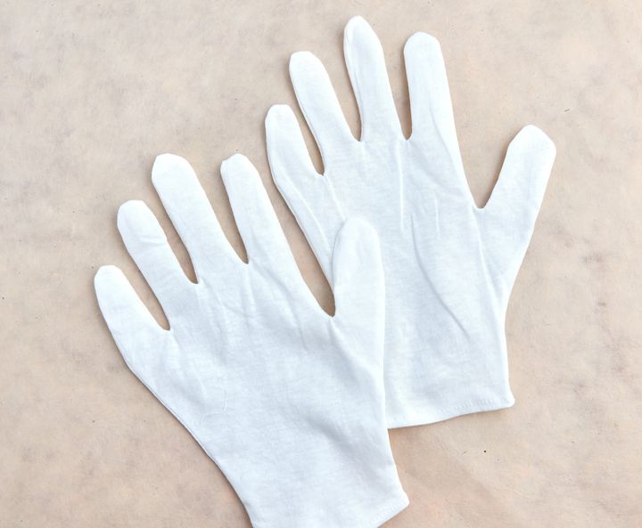 Plain cotton gloves are best.