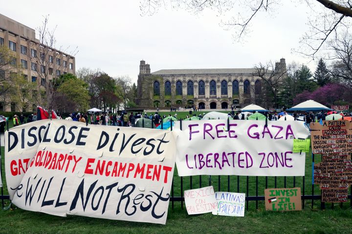 Signs are displayed outside a tent encampment at Northwestern University on Friday, April 26, 2024, in Evanston, Illinois. 