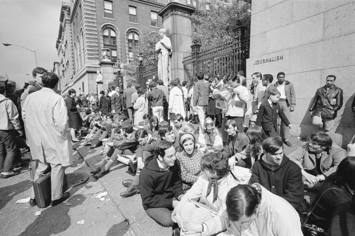 In an attempt to form a "human barricade" around Columbia University, students and sympathizers sit along the perimeter of the campus in 1968.