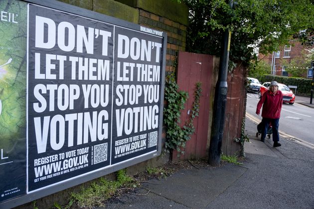 A government poster advises people to register to vote on the www.gov.uk website under the slogan 'Don't let them stop you voting'.