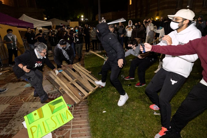 Counter protesters attack pro-Palestinian protesters at a pro-Palestinian encampment set up on the campus of the University of California Los Angeles (UCLA) as clashes erupt, in Los Angeles on May 1, 2024. (Photo by ETIENNE LAURENT/AFP via Getty Images)