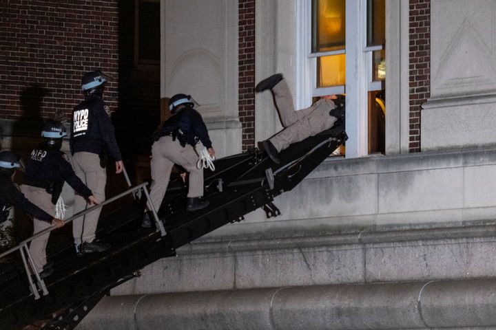 New York City police enter an upper floor of Hamilton Hall on the Columbia University campus in New York on April 30, after the building was taken over by protesters earlier that day.