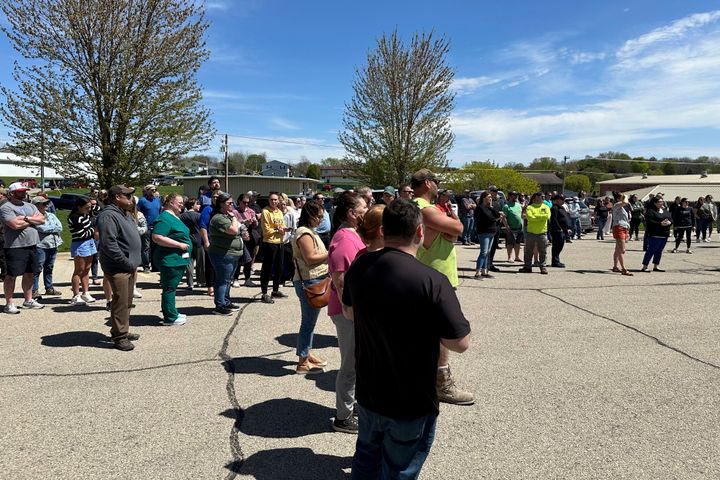 People wait for their children outside the Mount Horeb School District bus station in Mount Horeb, Wis., where students were taken after an active shooter situation at the middle school, on May 1, 2024.