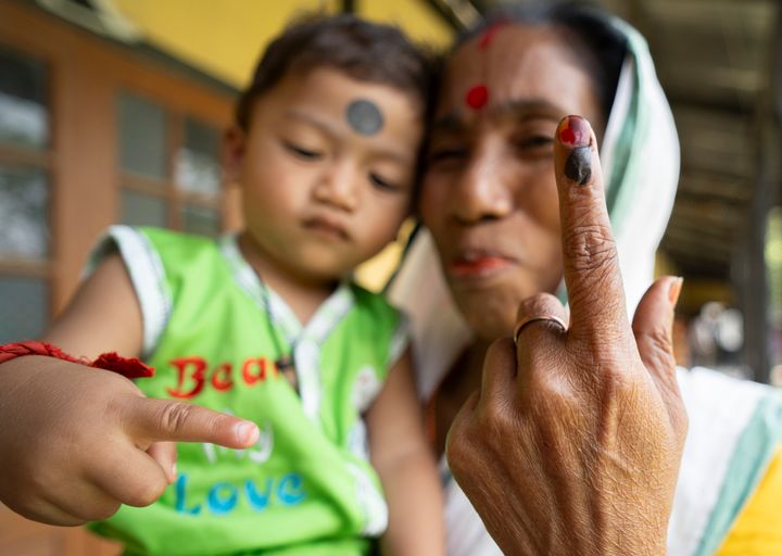 A woman is showing her inked finger after casting her vote in the second phase of India's general election at a polling station in Morigaon, Assam, India, on April 26, 2024. 