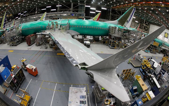 In this March 27, 2019, photo taken with a fisheye lens, a Max 8 airplane sits on the assembly line during a media tour at Boeing's 737 assembly facility in Renton, Washington.