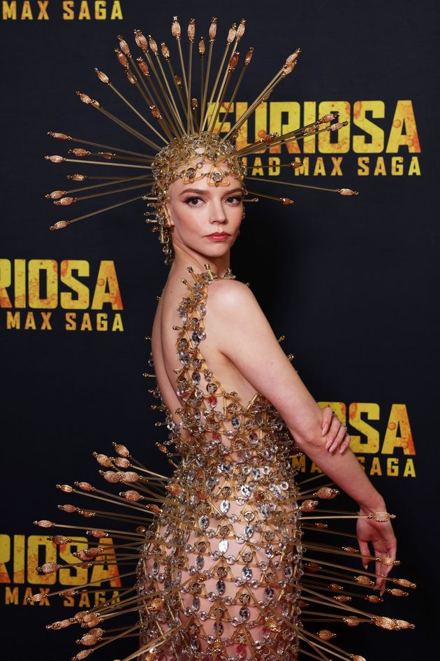 Anya reveals the back of her outfit on the Furiosa red carpet