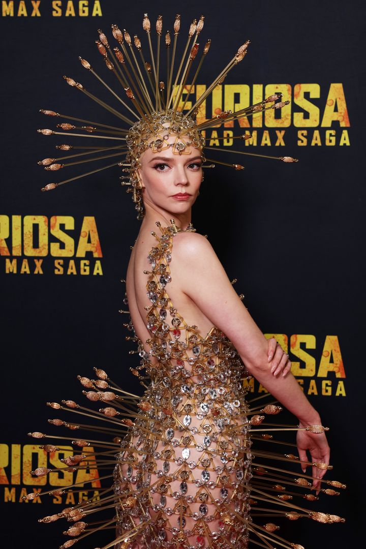 Anya reveals the back of her outfit on the Furiosa red carpet