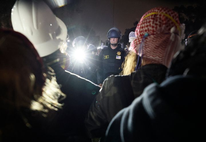 Police face off with pro-Palestinian students after destroying part of their encampment at the University of California, Los Angeles (UCLA) early on May 2, 2024. 