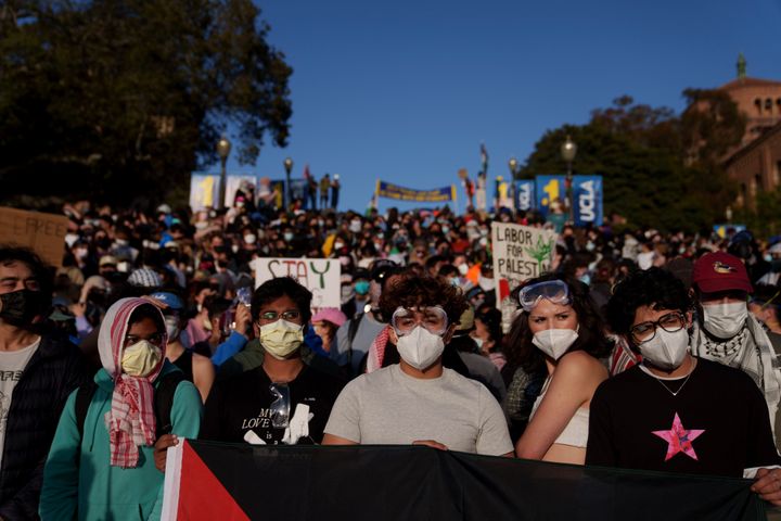 Pro-Palestinian protestors stand on stairs near an encampment at the University of California, Los Angeles campus on May 2, 2024 in Los Angeles, California.