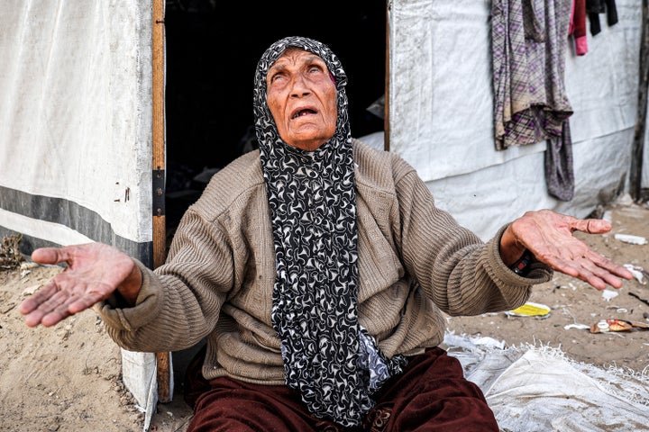 An elderly woman reacts as she sits outside a tent at a camp for displaced Palestinians in Rafah in the southern Gaza Strip on April 30, 2024. (Photo by AFP) (Photo by -/AFP via Getty Images)