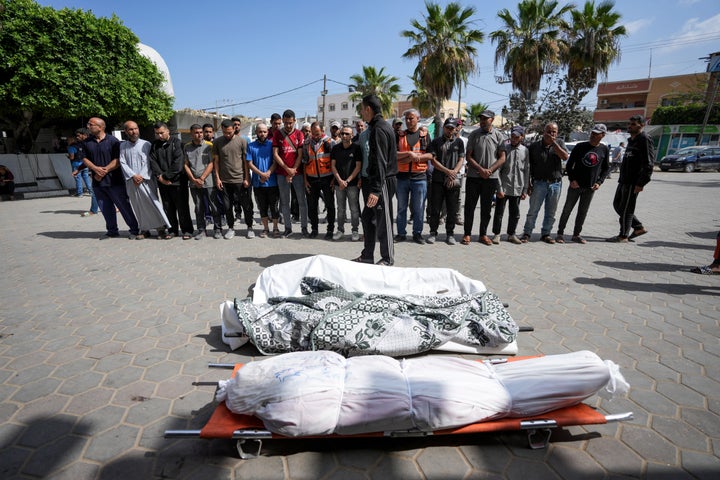 Des Palestiniens prient à côté des corps de leurs proches tués lors d'une frappe aérienne israélienne à Gaza Stirp, à l'hôpital Al Aqsa de Deir al Balah, Gaza, le samedi 4 mai 2024. (AP Photo/Abdel Kareem Hana)