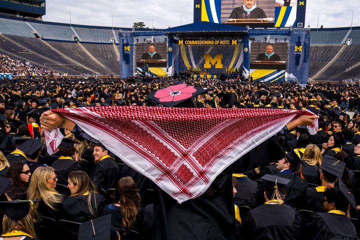 ANN ARBOR, MICHIGAN - MAY 4: A student holds a keffiyeh to begin a Pro-Palestinian protest during the University of Michigan's Spring Commencement ceremony on May 4, 2024 at Michigan Stadium in Ann Arbor, Michigan. (Photo by Nic Antaya/Getty Images)