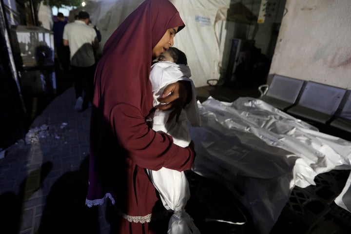 A Palestinian woman mourns her relative, 7-month old baby Hani Qeshta, who was killed in an Israeli bombardment on a residential building with Qeshta's family, at the morgue of Al Najjar hospital in Rafah, southern Gaza Strip, Sunday, May 5, 2024. (AP Photo/Ismael Abu Dayyah)