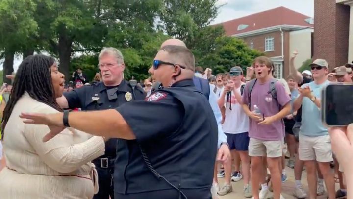In this photo taken from video provided by Stacey J. Spiehler, a pro-Palestinian protester is confronted by hecklers at the University of Mississippi.